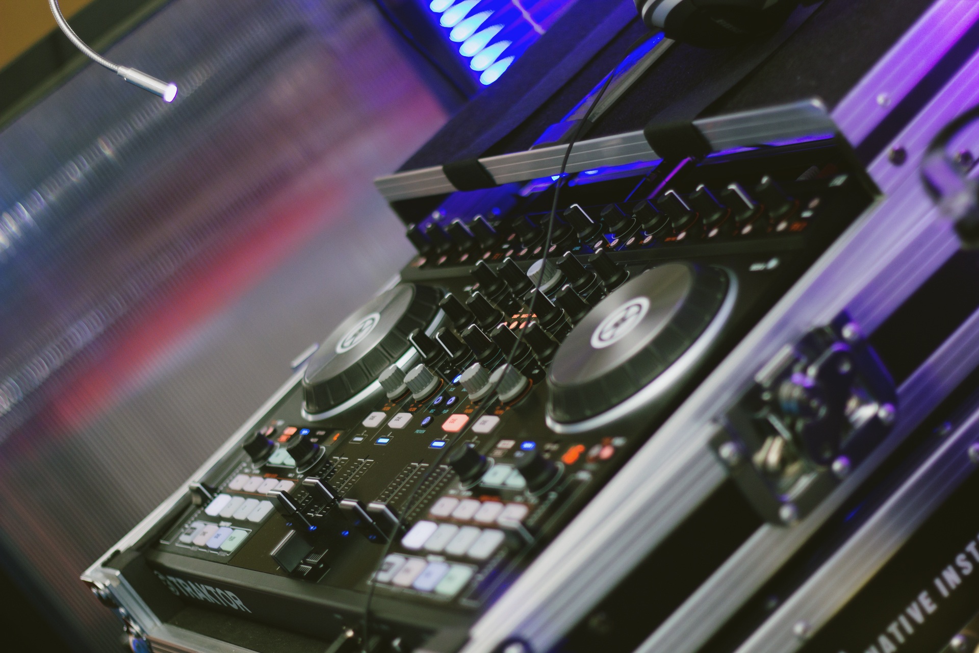 A DJ controller with jog wheels, faders and knobs, photographed at an angle.